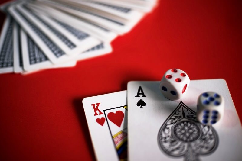 gambling cards and dices on table cashless casinos